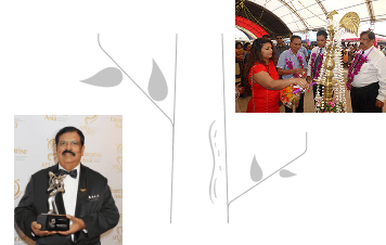 Business leader holding an award trophy and participating in a ceremonial event with traditional decorations